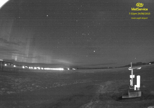 Meteorologists and astronomers both spend a lot of time looking at the sky—this webcam image from the weather station at Invercargill captured a lovely example of the Aurora Australis. In the foreground are the instruments used to measure cloud height and the type of weather.